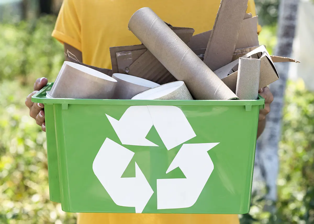 man holding junk recycling basket