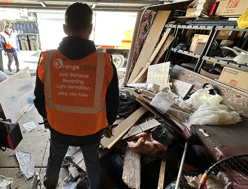 man looking at the junk in the garage