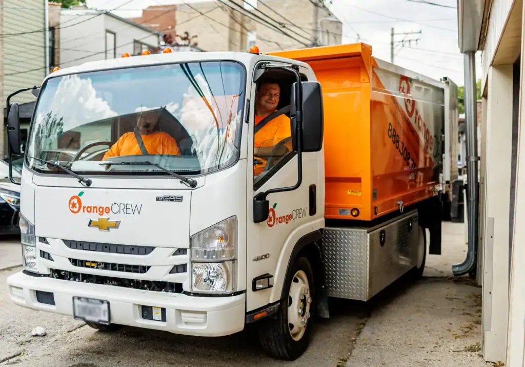 two men in the junk removal truck
