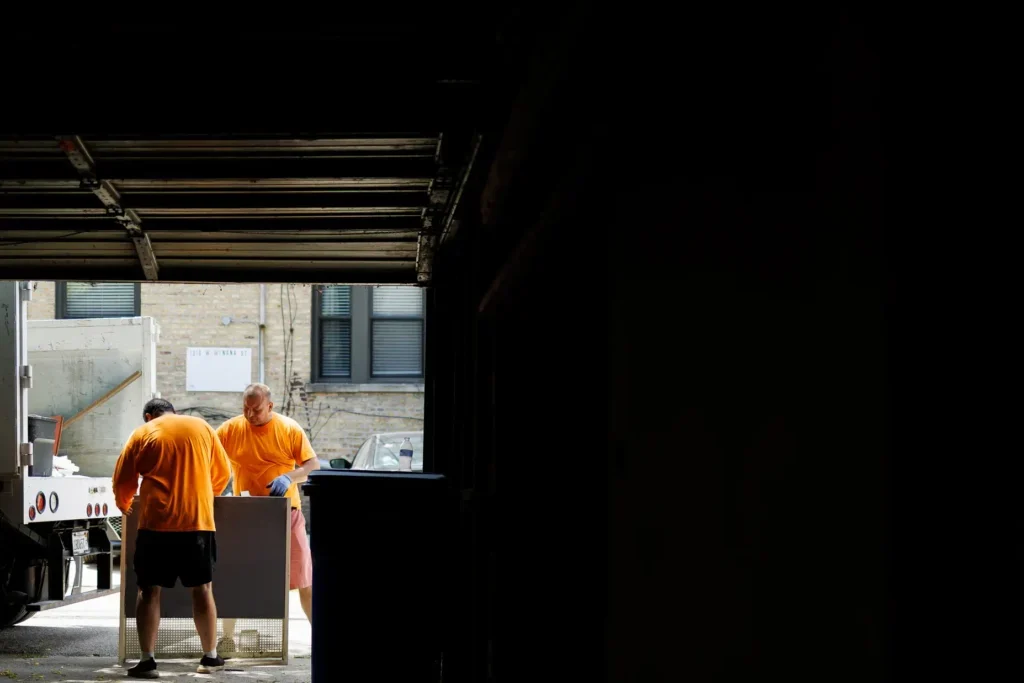 two men in the distance working on garbage removal project