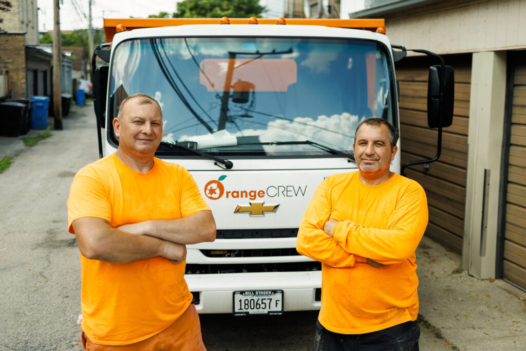 junk removal crew standing in front of a truck