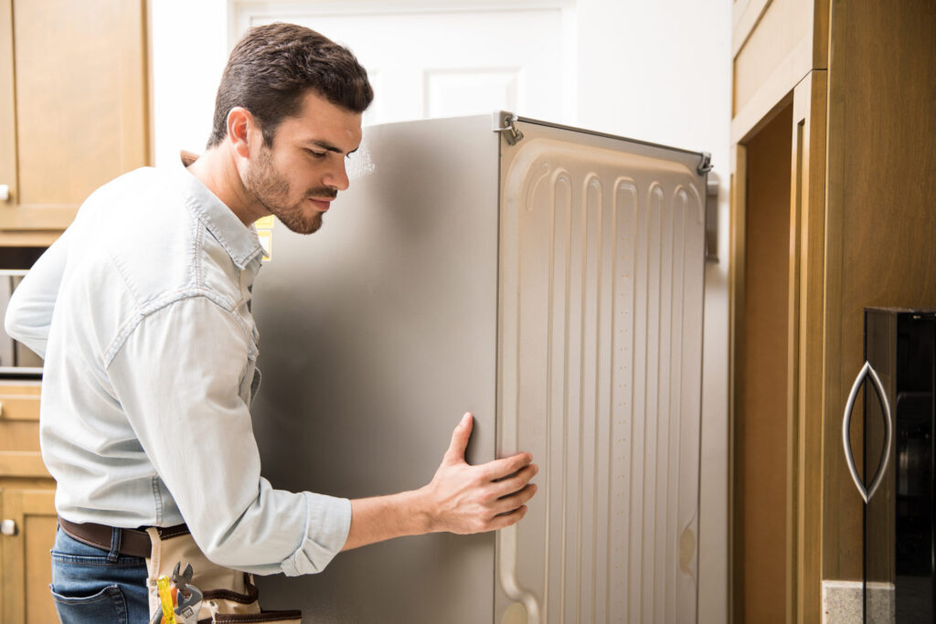 man moving a fridge
